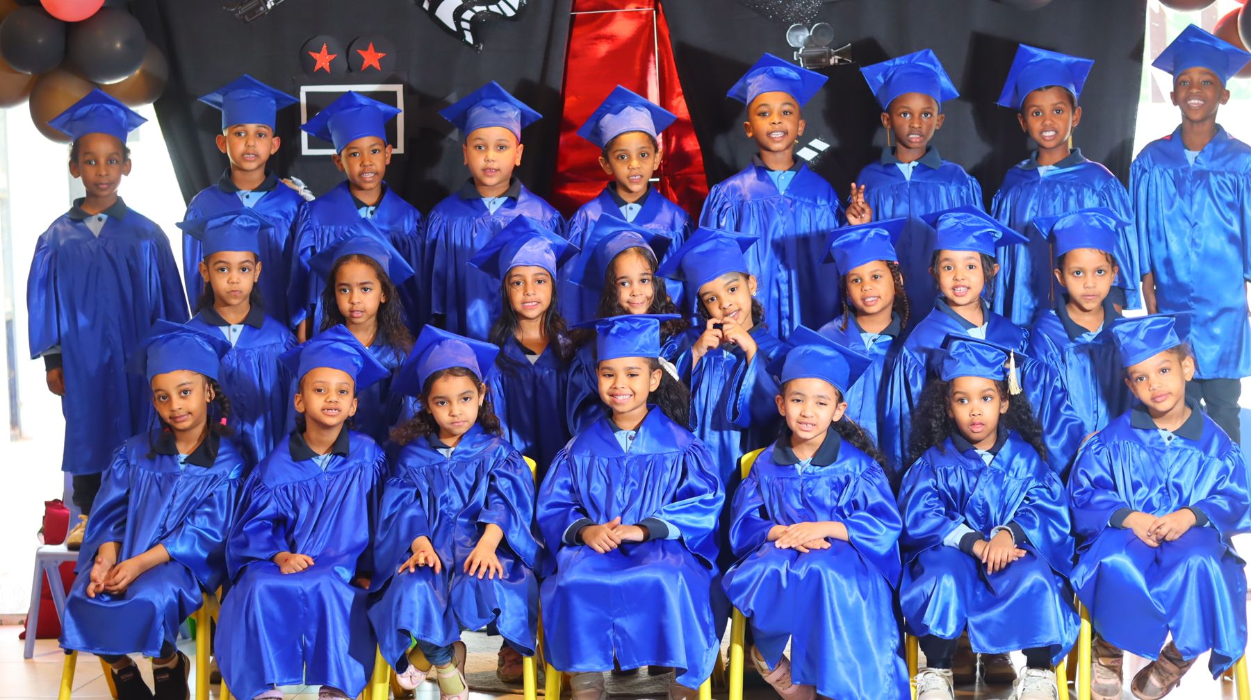 Kindergarten children in graduation caps and gowns