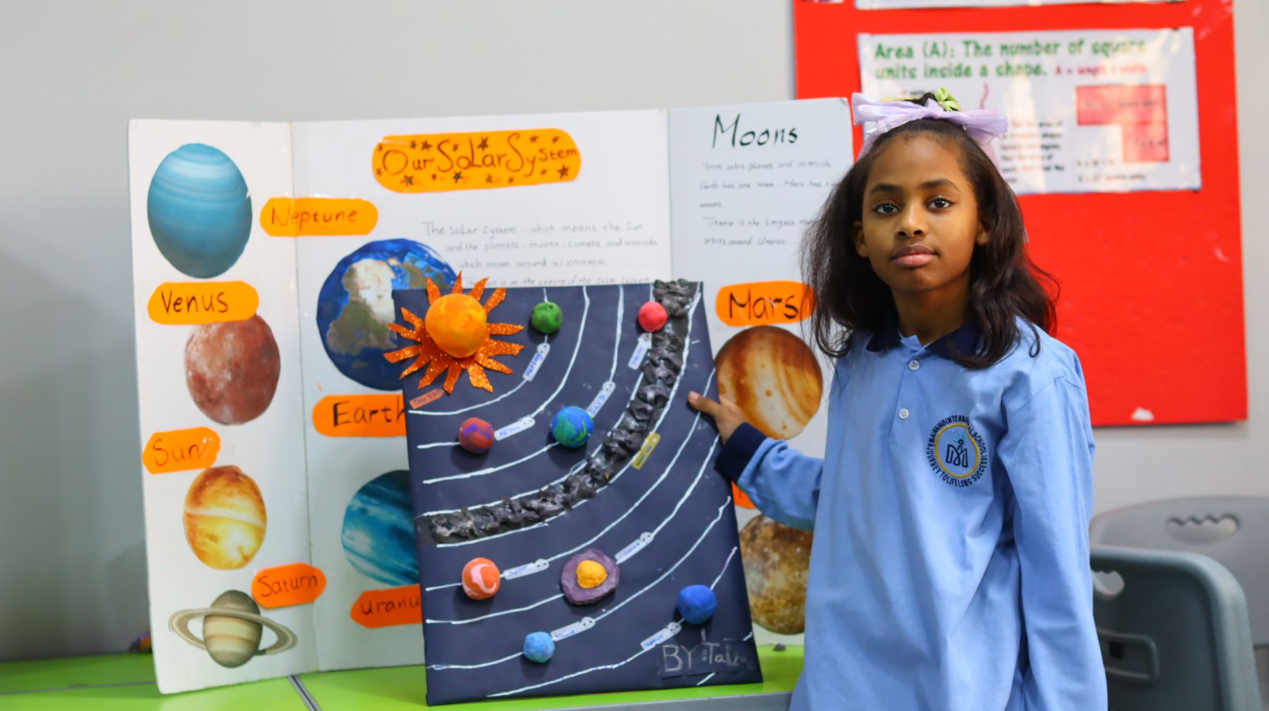 A student presenting her solar system project at the Science Fair